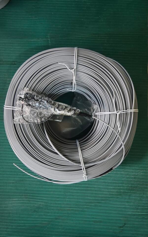 Provide top-down view of coiled cable for product presentation. Top-down view of gray fiber optic coil with bubble-wrapped connector on green surface.
