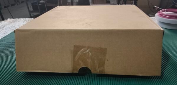 Show larger packaging box for bulk inventory visualization. Brown cardboard box with tape on green surface, ready for shipping.